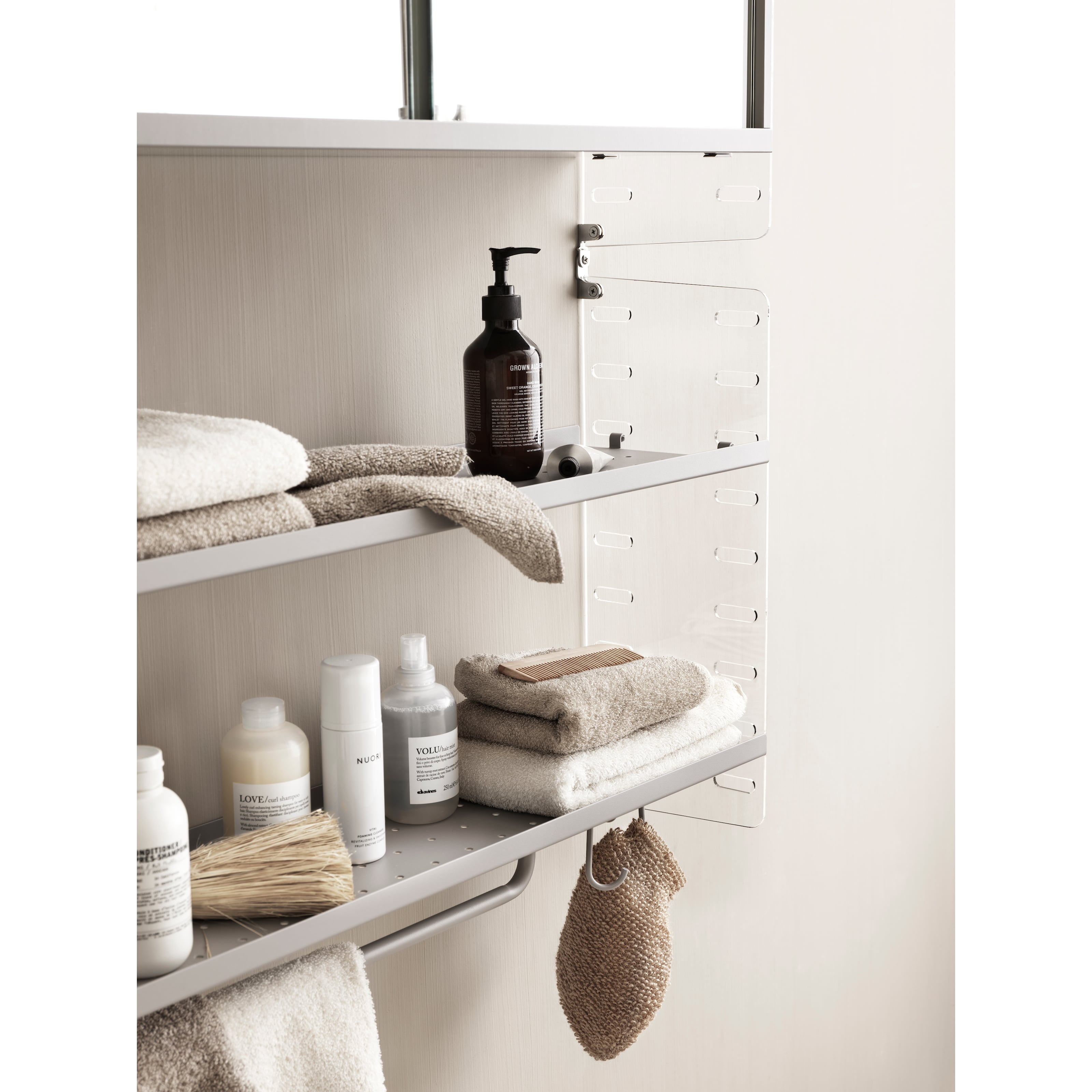 For the smallest bathrooms, we have a wall-hung 20 cm deep and 50 cm high combination with wall panels in clear plex. It only has two shelves, making it possible for you to store higher objects. The lower metal shelf has added hooks and a rod for increased storage.
